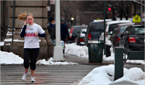 Runner crossing street with iPod